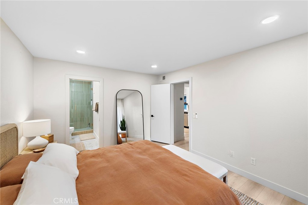 74 Corniche Drive, Unit D Dana Point, CA 92629 - Photo 10 of 22 a bedroom with a large bed and wooden floor