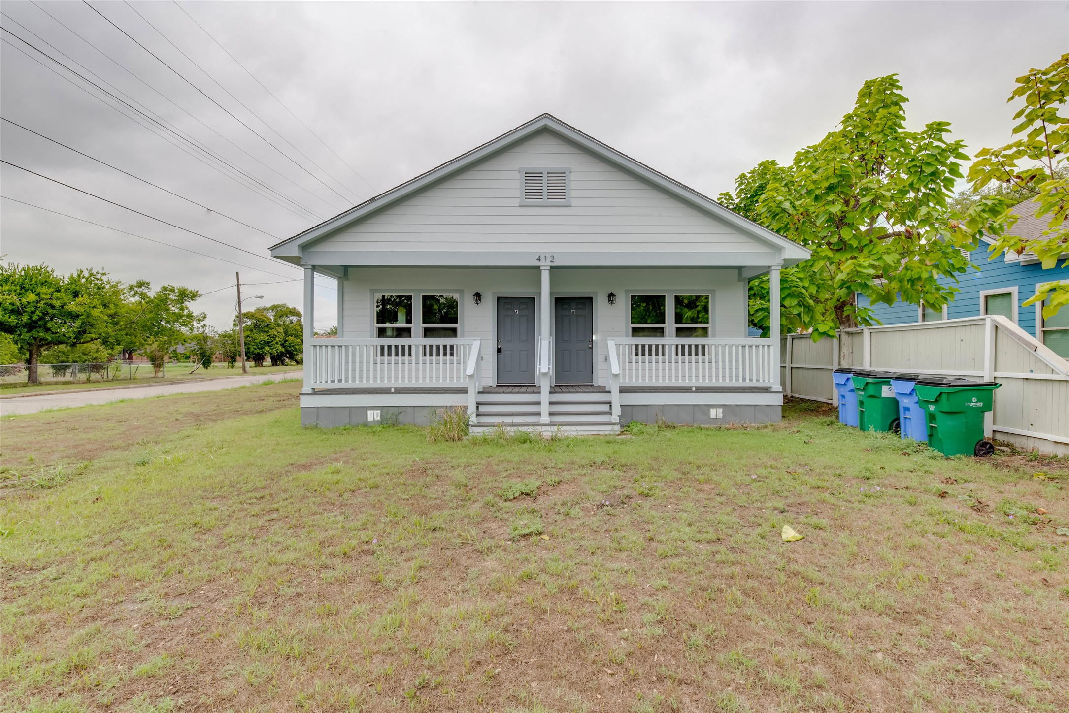 412 Booth Street, Unit A Taylor, TX 76574 - Photo 1 of 1 a front view of a house with garden