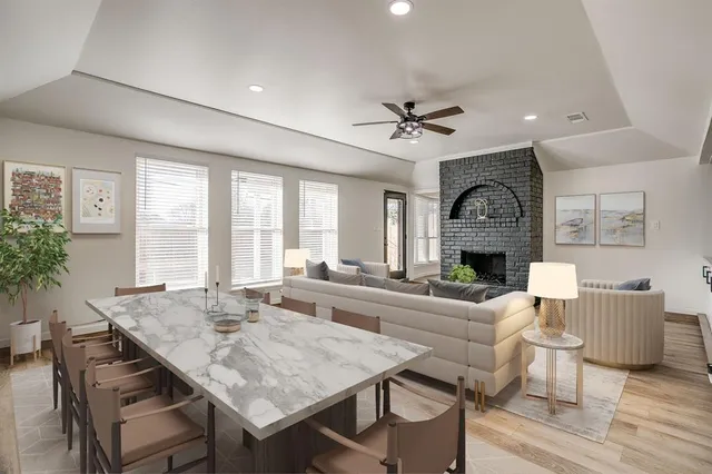 a living room with fireplace furniture and a large window