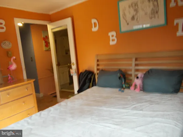 a bedroom with a bed and a desk