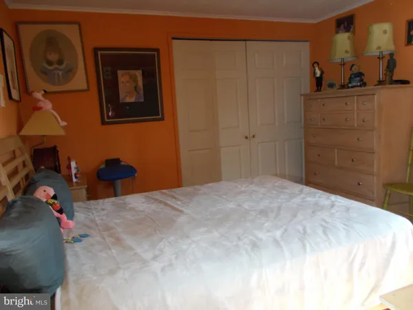 a bedroom with a bed and cabinets