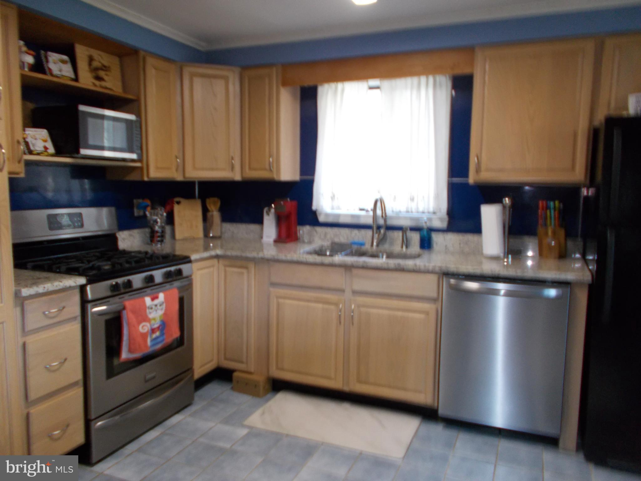 6 Cheyenne Drive Hazleton, PA 18202 - Photo 7 of 20 a kitchen with stainless steel appliances granite countertop a stove a sink and a microwave