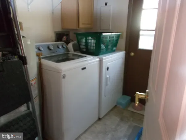 a room with a sink and washing machine