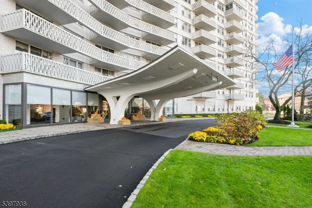 a view of a tall building next to a road