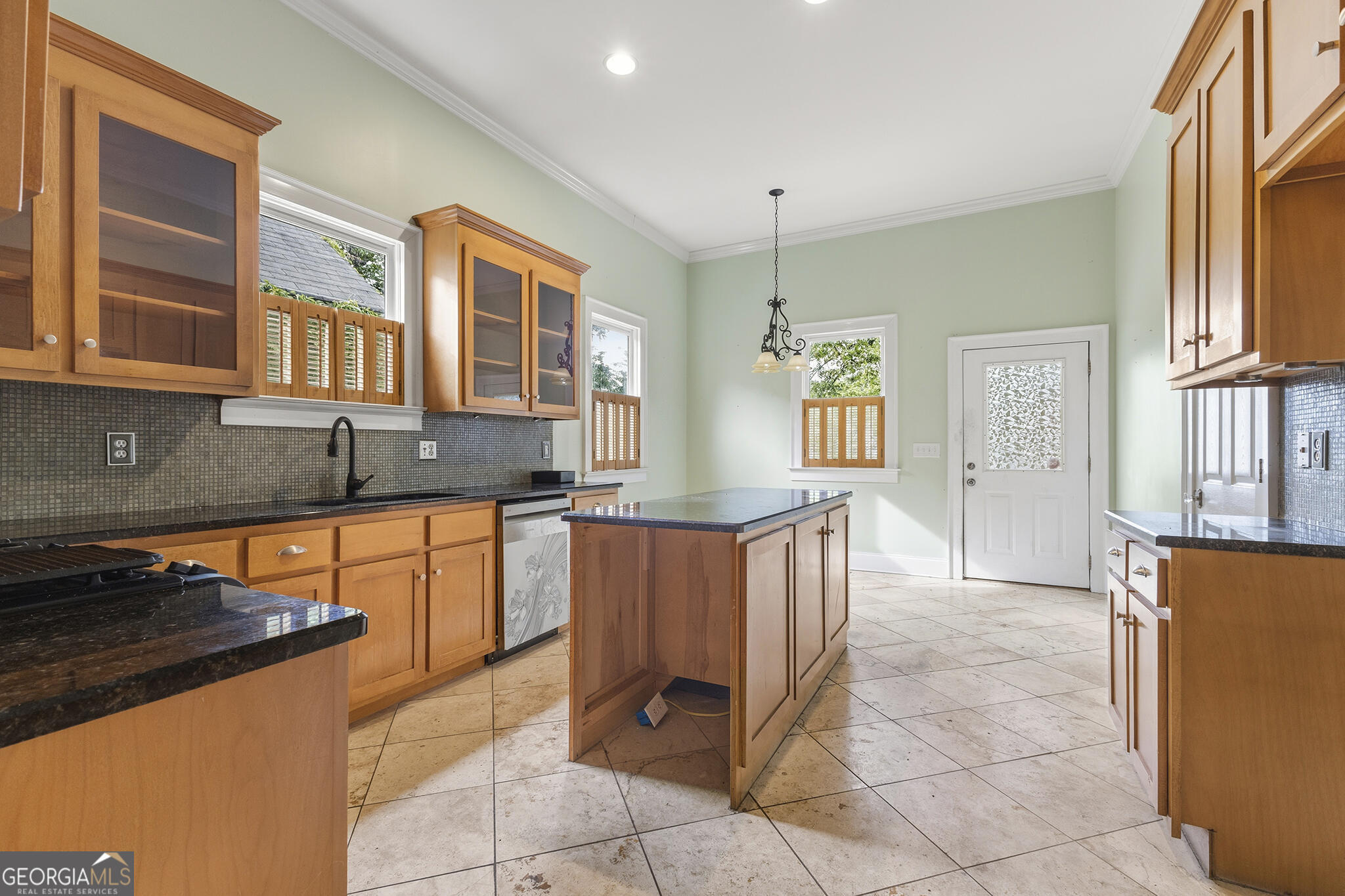 1469 Chestnut Street Macon, GA 31201 - Photo 21 of 26 a kitchen with stainless steel appliances granite countertop a refrigerator and wooden cabinets