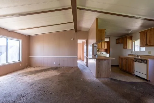 a view of a kitchen with a sink and a kitchen counter top space