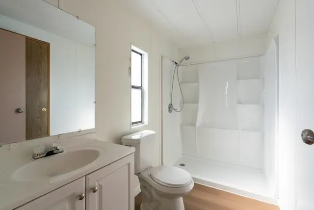 a bathroom with a sink toilet and shower