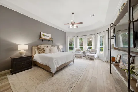 a bedroom with a bed and a flat screen tv