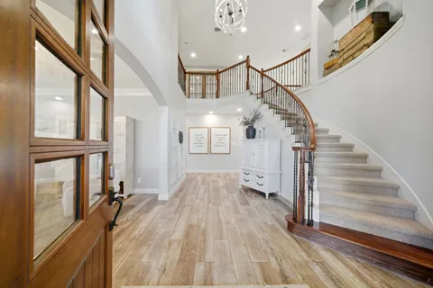 a living room with furniture and a chandelier