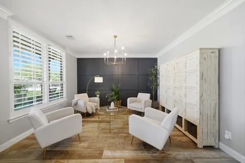 a view of a livingroom with furniture window and wooden floor