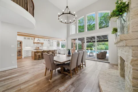 a kitchen with stainless steel appliances a stove a sink dishwasher and a refrigerator with wooden floor