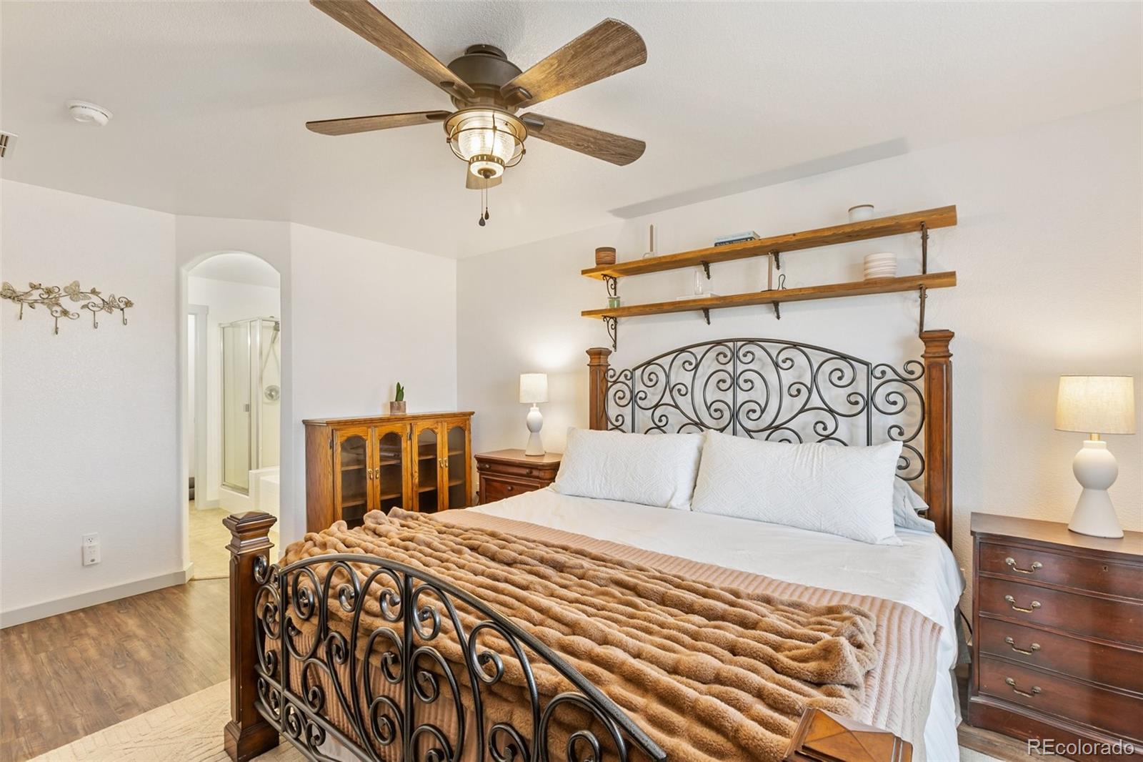 9201 Ballybunion Road Peyton, CO 80831 - Photo 12 of 32 a bedroom with a bed and a chandelier