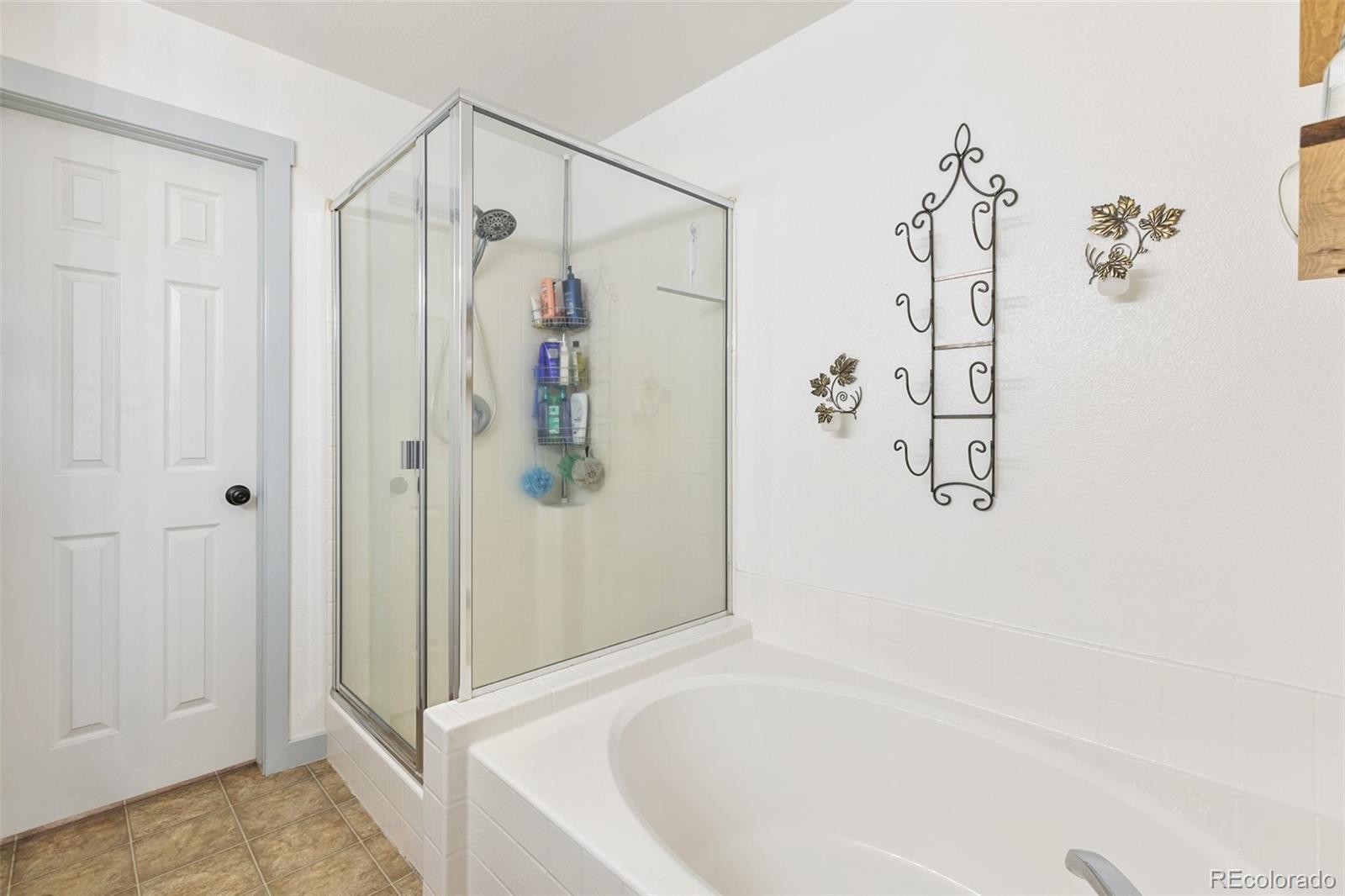 9201 Ballybunion Road Peyton, CO 80831 - Photo 15 of 32 a bathroom with a shower and a tub