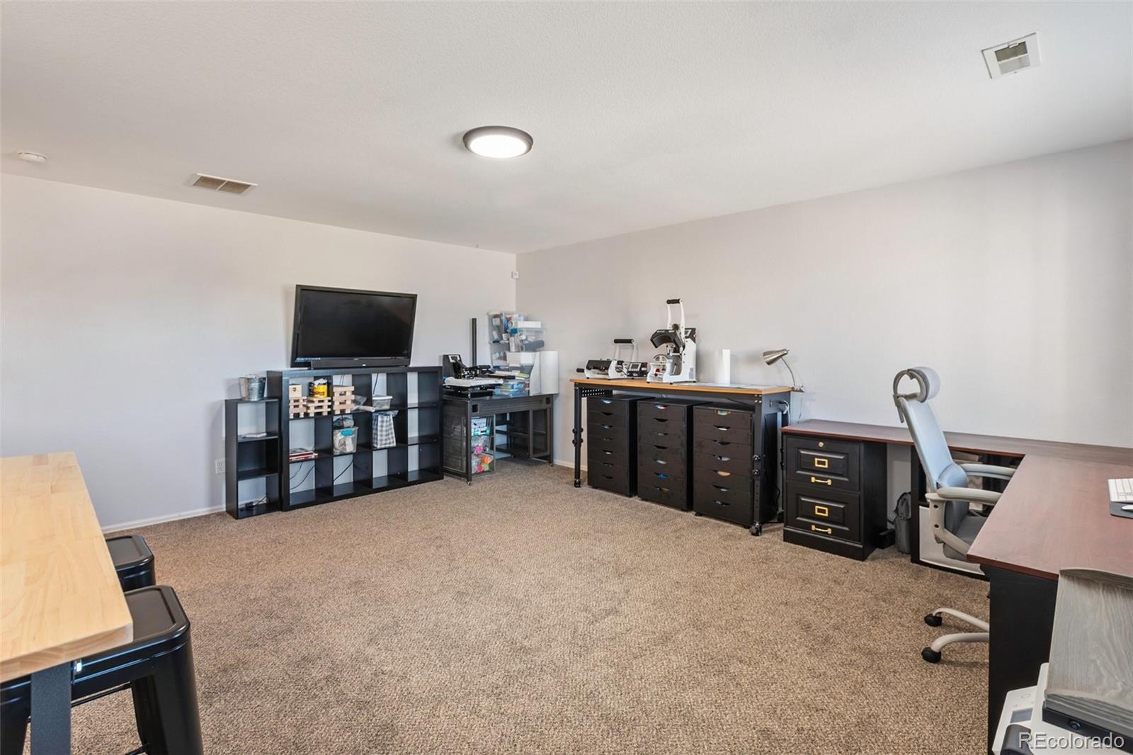 9201 Ballybunion Road Peyton, CO 80831 - Photo 17 of 32 a view of a workspace with furniture and natural light