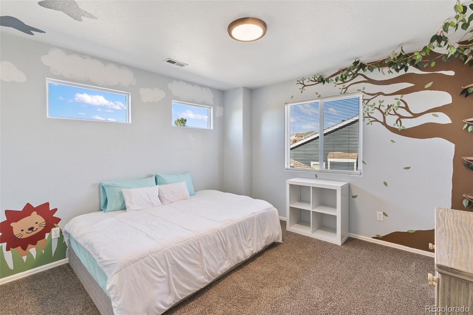 9201 Ballybunion Road Peyton, CO 80831 - Photo 18 of 32 a bedroom with a bed and cabinets