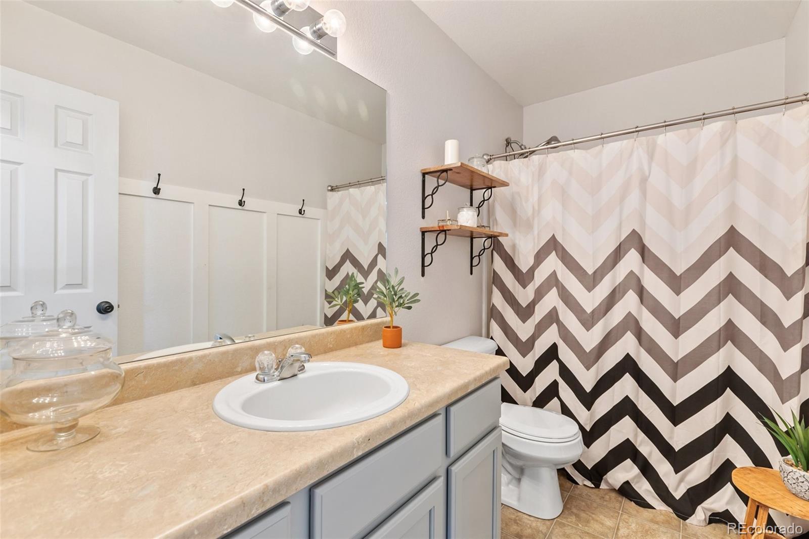 9201 Ballybunion Road Peyton, CO 80831 - Photo 22 of 32 a bathroom with a sink and a mirror