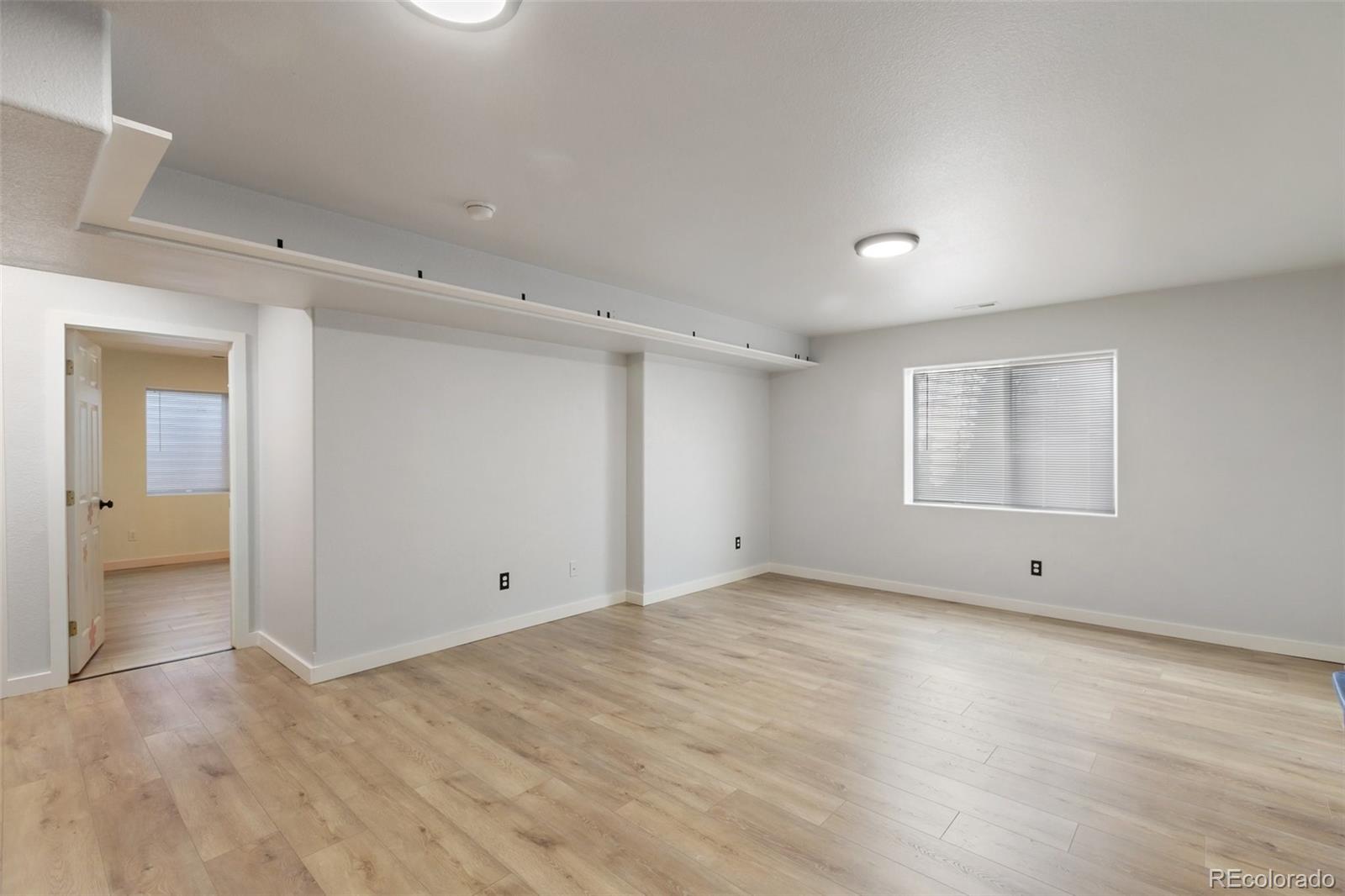 9201 Ballybunion Road Peyton, CO 80831 - Photo 23 of 32 a view of an empty room with wooden floor