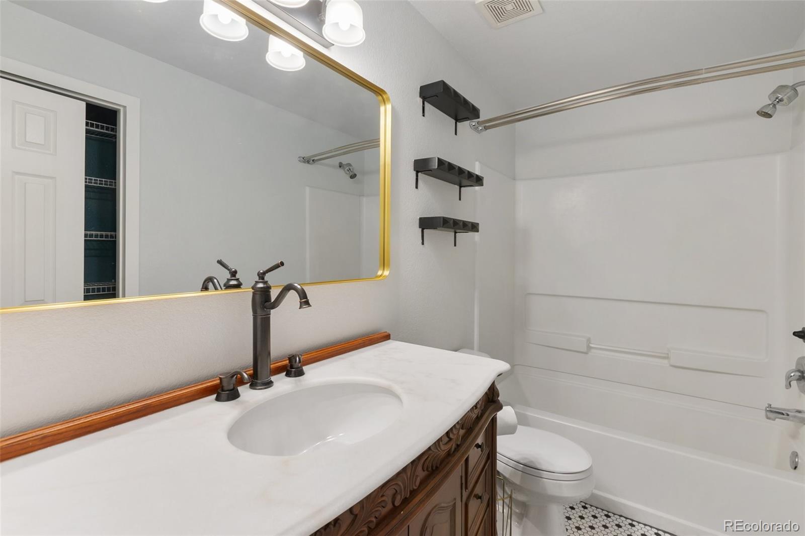 9201 Ballybunion Road Peyton, CO 80831 - Photo 24 of 32 a bathroom with a sink toilet and shower