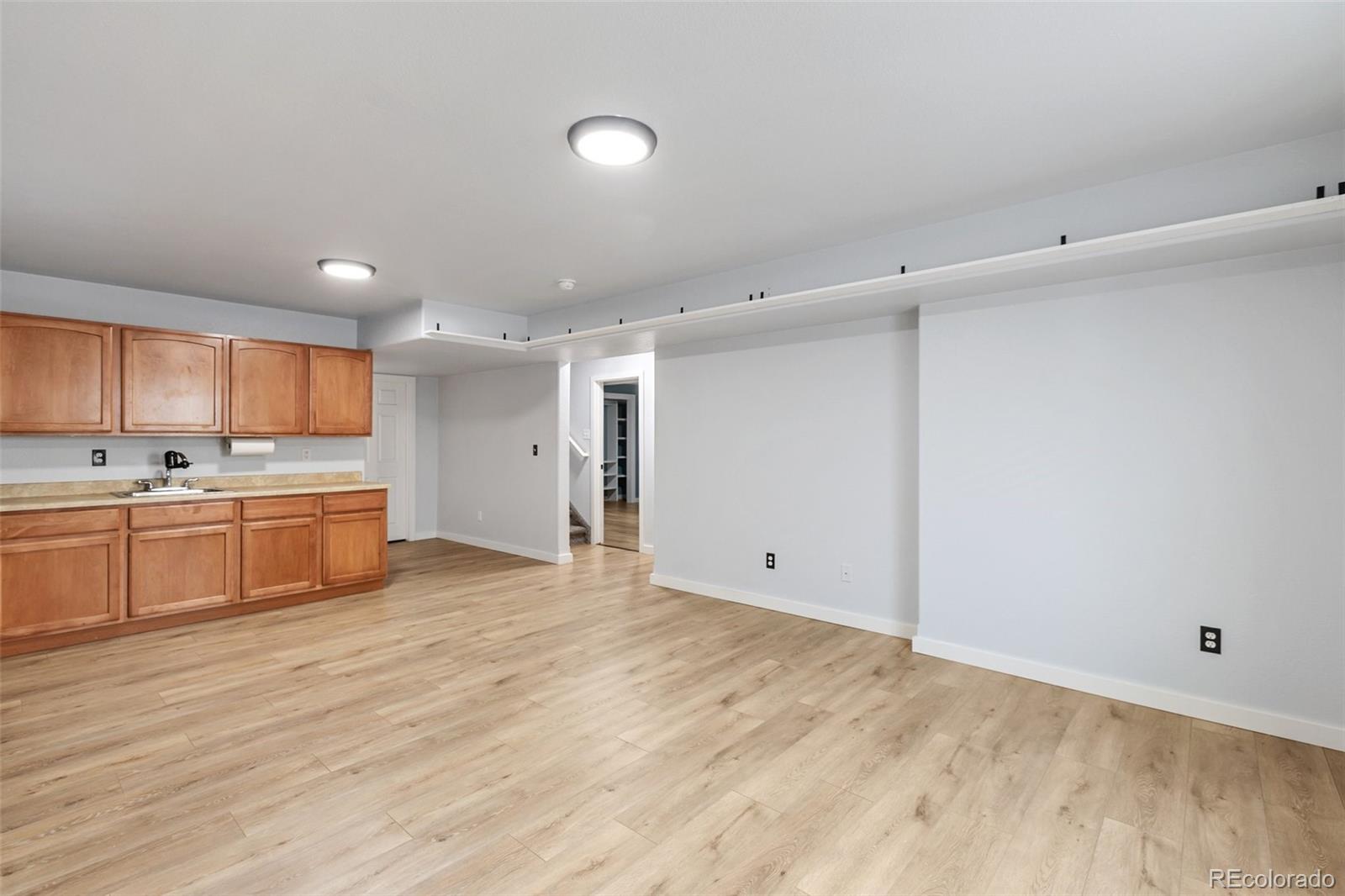 9201 Ballybunion Road Peyton, CO 80831 - Photo 25 of 32 a large white kitchen with a sink and cabinets