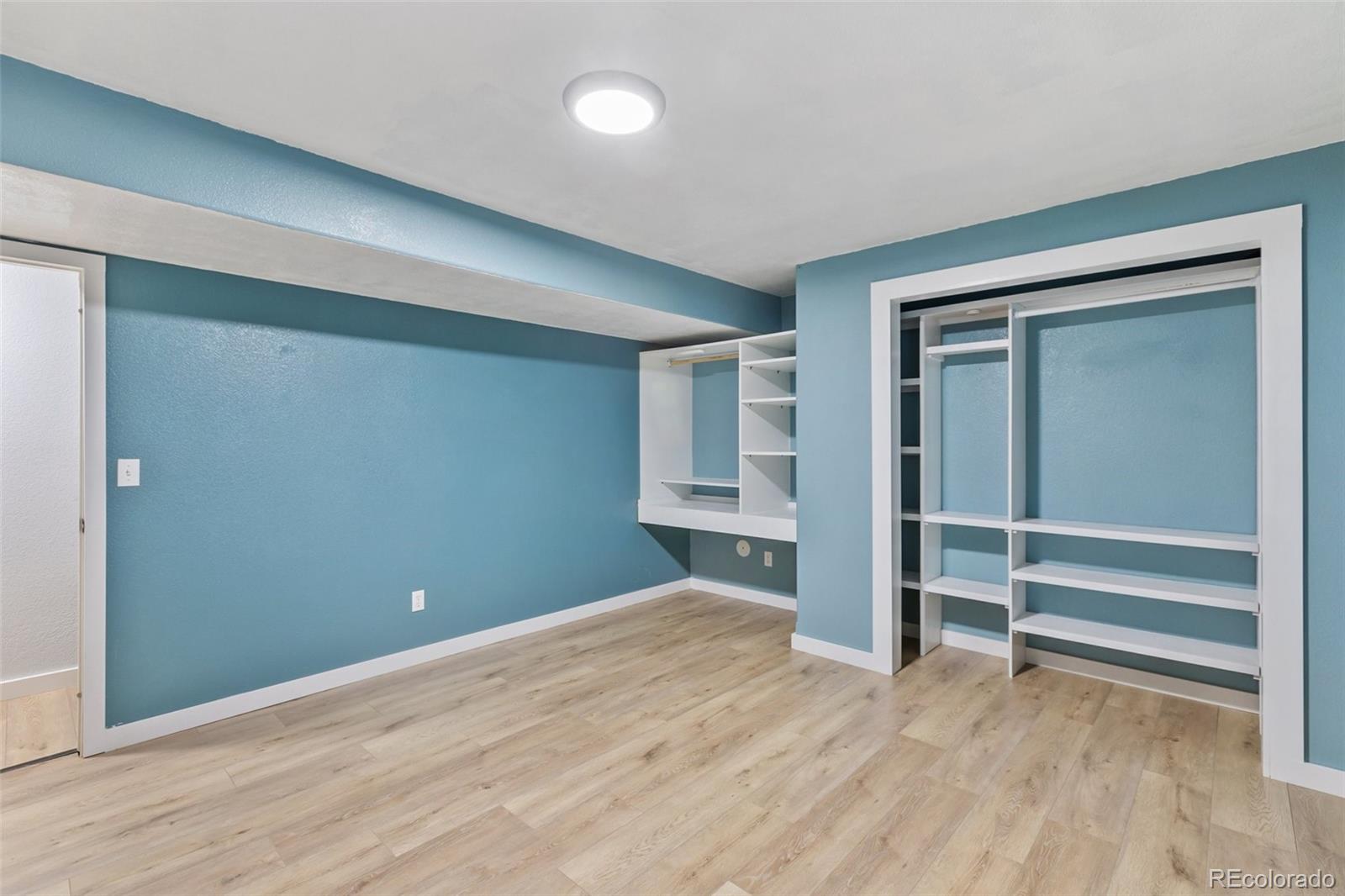 9201 Ballybunion Road Peyton, CO 80831 - Photo 27 of 32 a view of empty room with wooden floor and fan