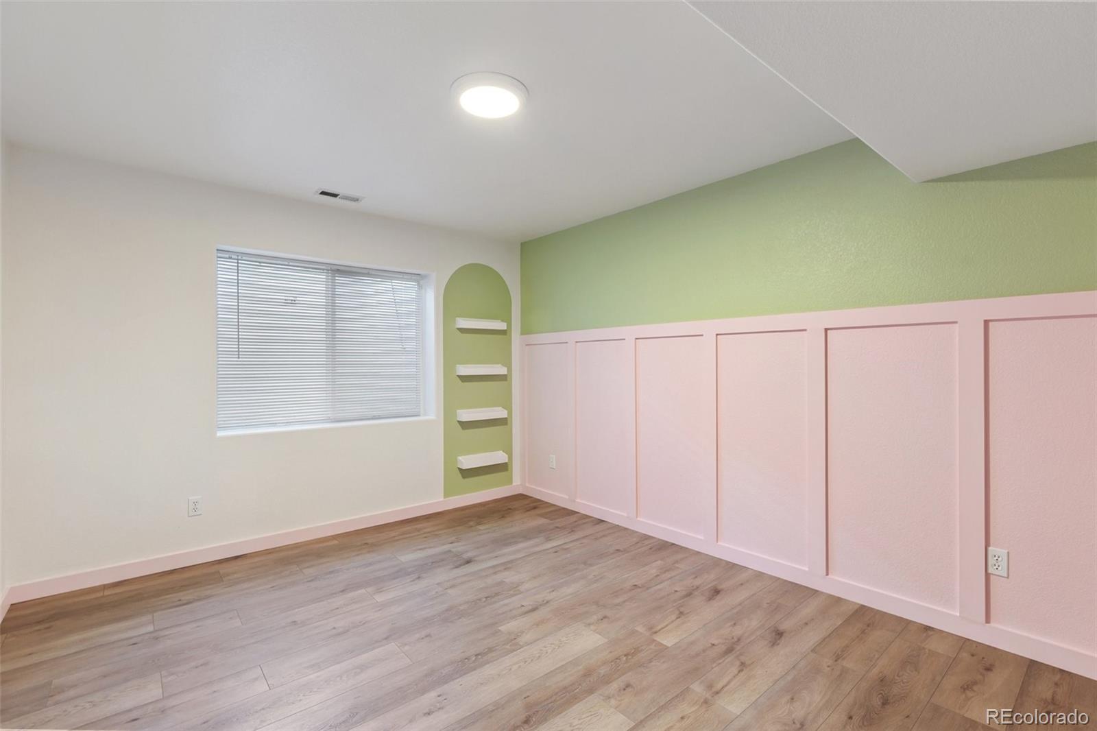 9201 Ballybunion Road Peyton, CO 80831 - Photo 28 of 32 an empty room with wooden floor and windows