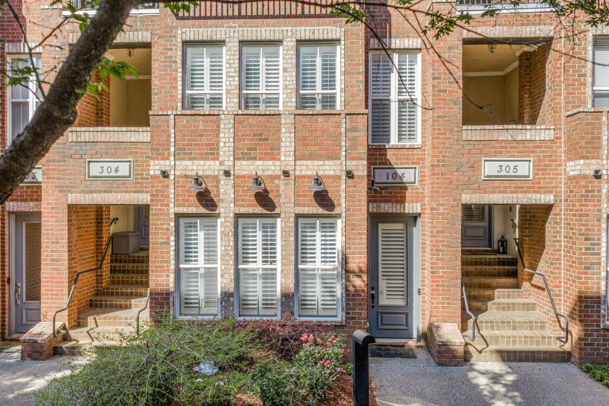 79 Shoemaker Court, Unit 104 Memphis, TN 38103 - Photo 1 of 22 front view of a brick house with a small yard