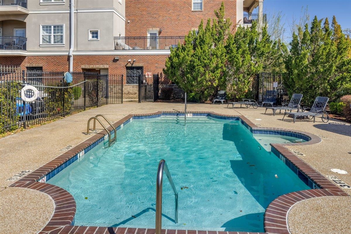 79 Shoemaker Court, Unit 104 Memphis, TN 38103 - Photo 20 of 22 a swimming pool with outdoor seating and yard