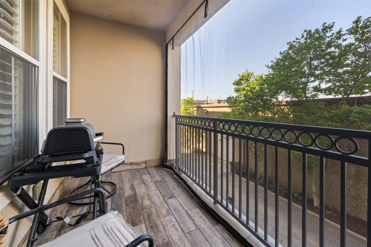 79 Shoemaker Court, Unit 104 Memphis, TN 38103 - Photo 5 of 22 a view of balcony with wooden floor and seating space