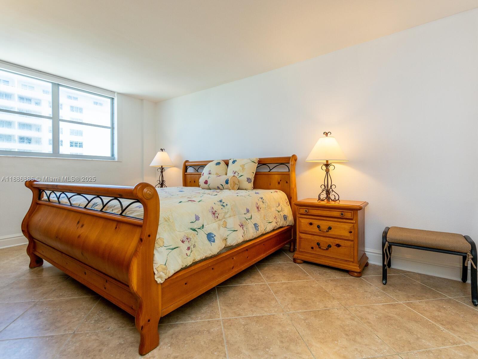 9273 Collins Avenue, Unit 703 Surfside, FL 33154 - Photo 12 of 49 a bedroom with a bed and a window