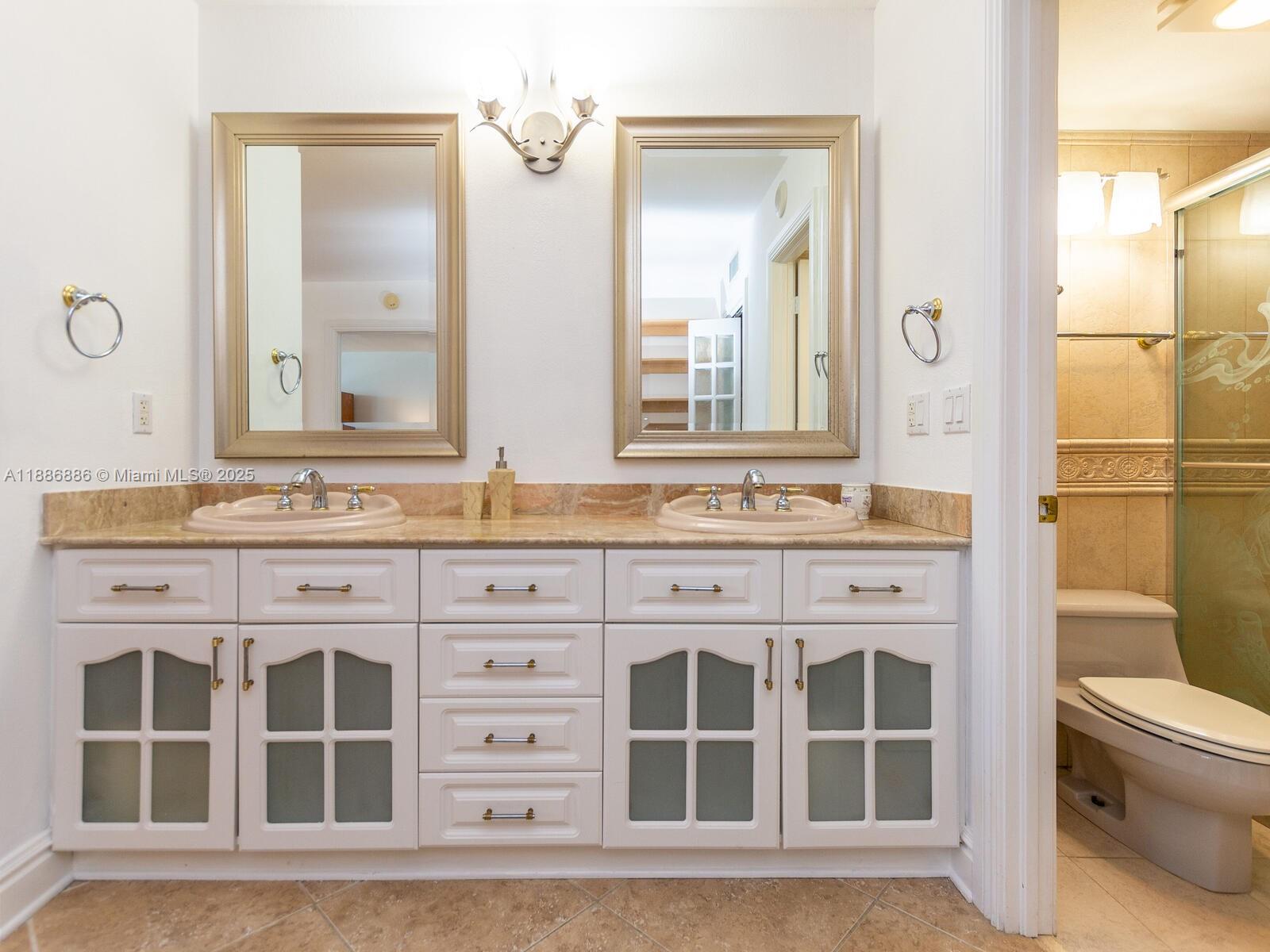 9273 Collins Avenue, Unit 703 Surfside, FL 33154 - Photo 15 of 49 a bathroom with a granite countertop sink mirror and a shower