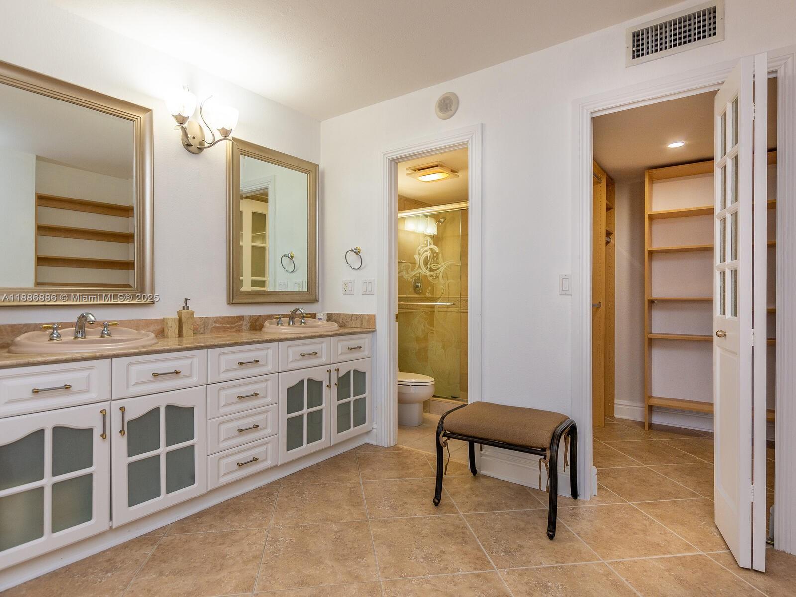 9273 Collins Avenue, Unit 703 Surfside, FL 33154 - Photo 16 of 49 a bathroom with a sink and a mirror