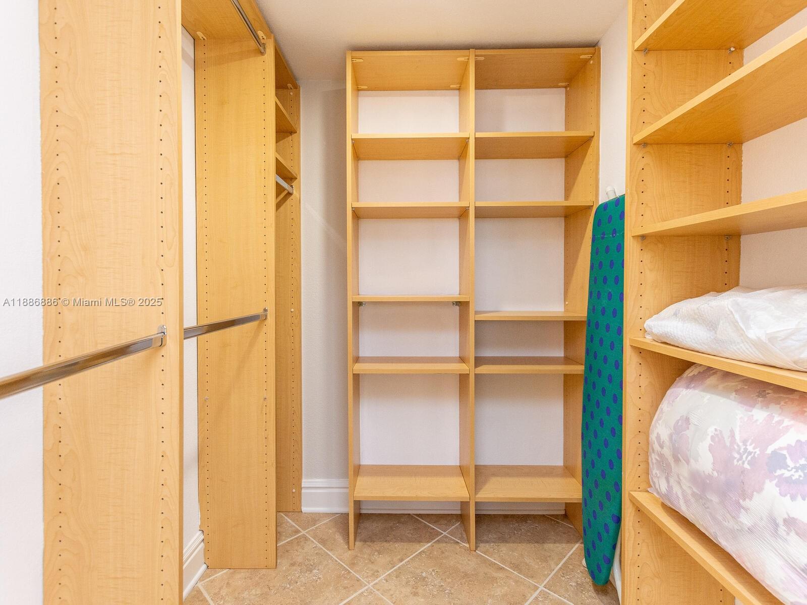 9273 Collins Avenue, Unit 703 Surfside, FL 33154 - Photo 18 of 49 a view of walk in closet with empty racks