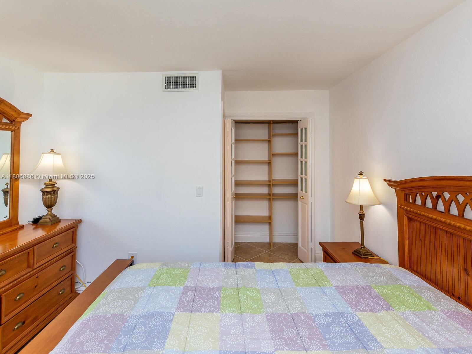 9273 Collins Avenue, Unit 703 Surfside, FL 33154 - Photo 21 of 49 a bedroom with a bed and a cabinets