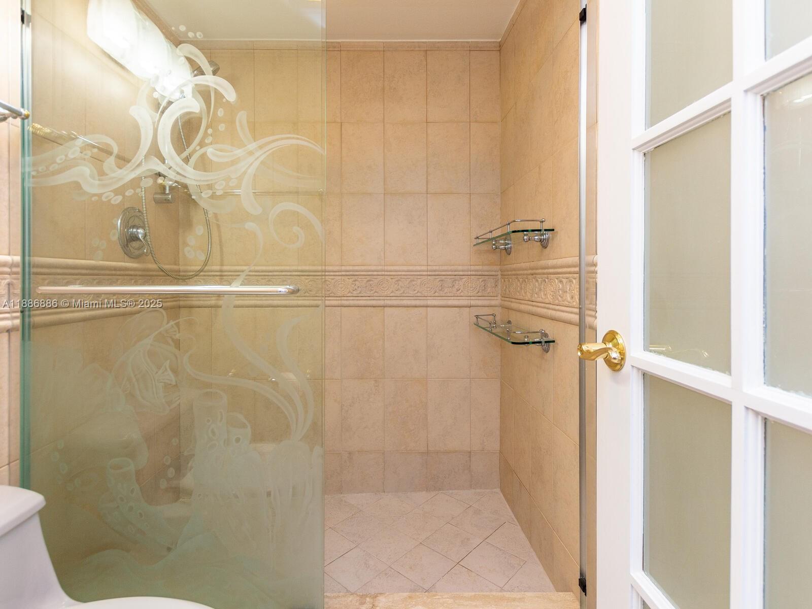 9273 Collins Avenue, Unit 703 Surfside, FL 33154 - Photo 25 of 49 a bathroom with a shower
