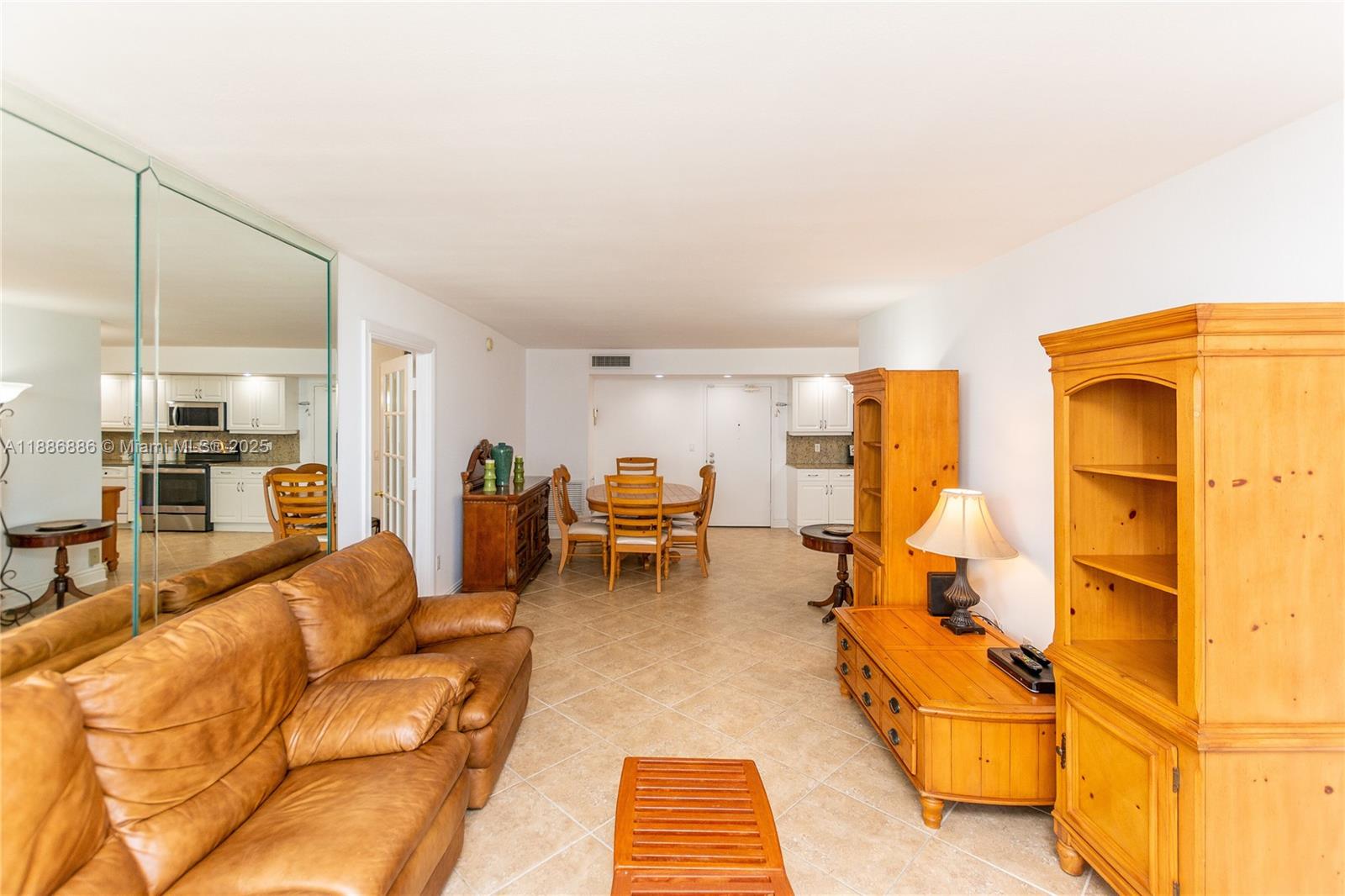 9273 Collins Avenue, Unit 703 Surfside, FL 33154 - Photo 3 of 49 a living room with furniture and a table
