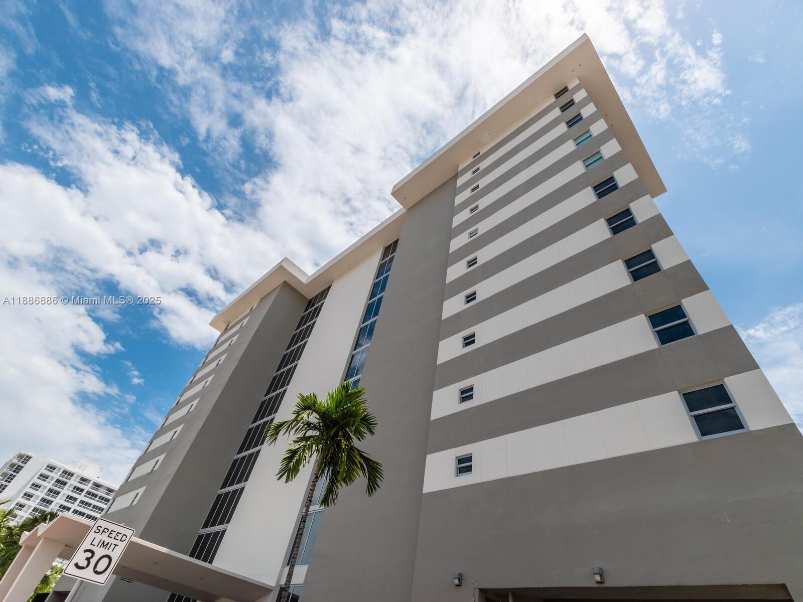 9273 Collins Avenue, Unit 703 Surfside, FL 33154 - Photo 38 of 49 a view of staircase with wooden floor and white walls