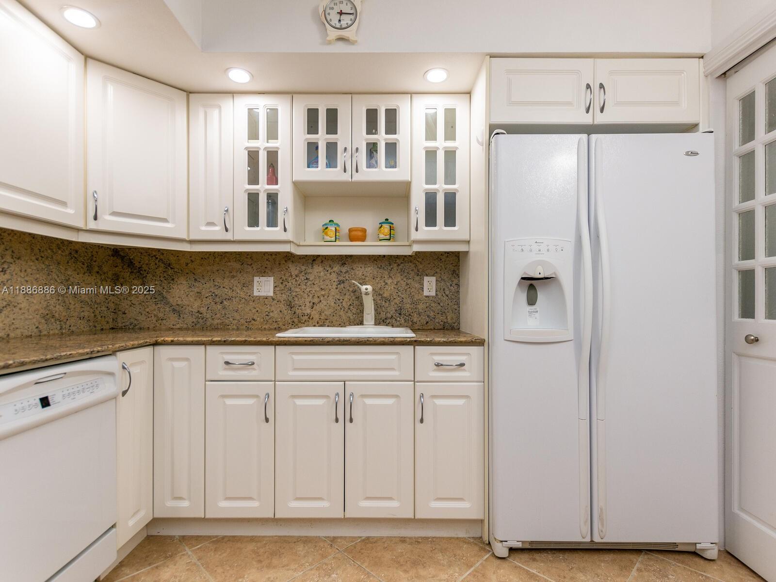 9273 Collins Avenue, Unit 703 Surfside, FL 33154 - Photo 10 of 49 a kitchen with stainless steel appliances granite countertop a refrigerator and a cabinets