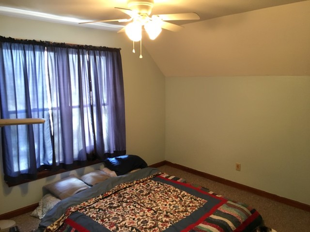 733 North 12th Street DeKalb, IL 60115 - Photo 8 of 14 a view of a bedroom with furniture and staircase