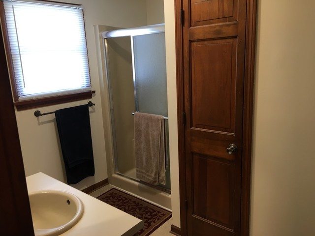 733 North 12th Street DeKalb, IL 60115 - Photo 9 of 14 a bathroom with a toilet and a shower