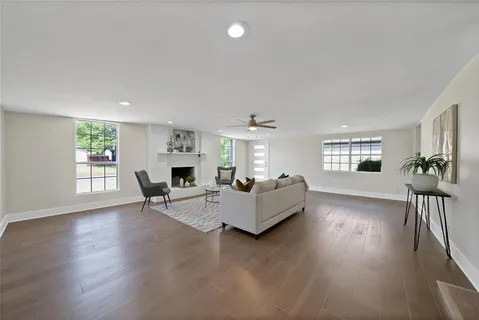 a living room with furniture wooden floor and a fireplace