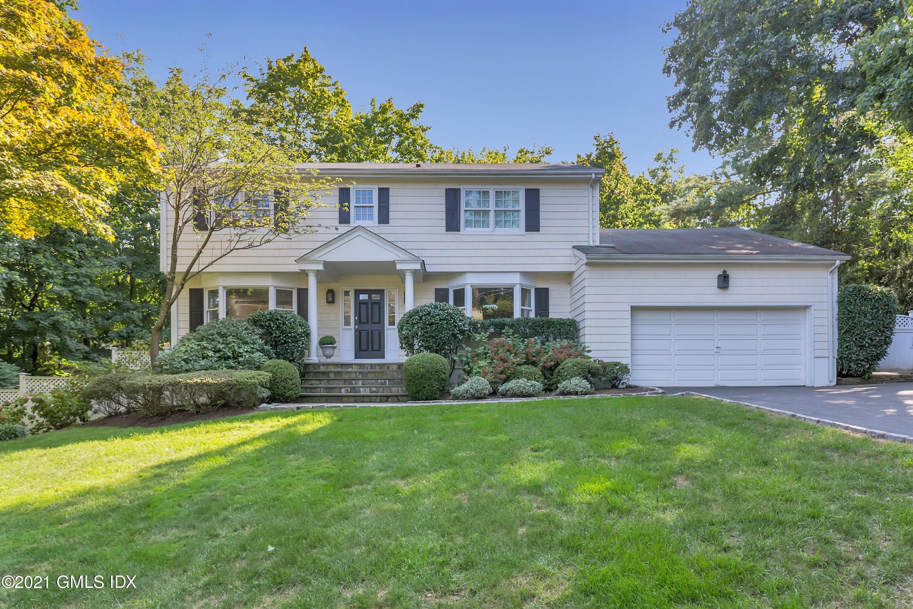 23 Stanwich Road Greenwich, CT 06830 - Photo 1 of 25 a front view of a house with a yard and garage