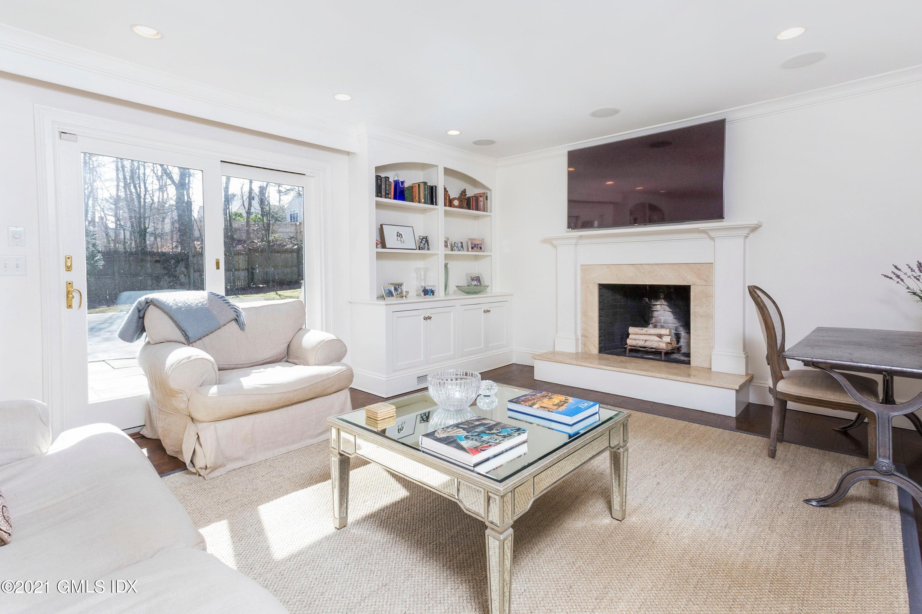 23 Stanwich Road Greenwich, CT 06830 - Photo 12 of 25 a living room with furniture a flat screen tv and a fireplace