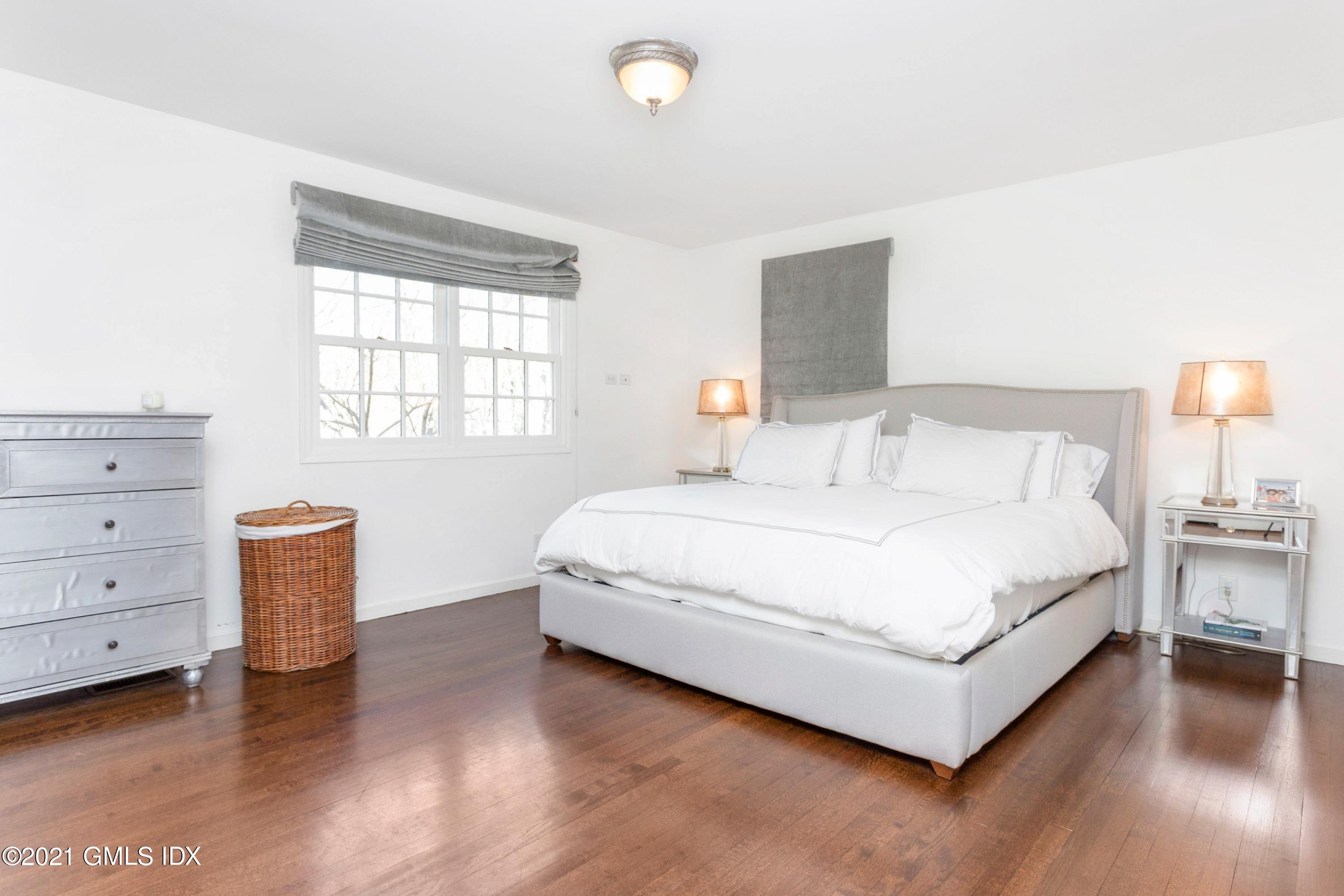 23 Stanwich Road Greenwich, CT 06830 - Photo 17 of 25 a spacious bedroom with a bed and window