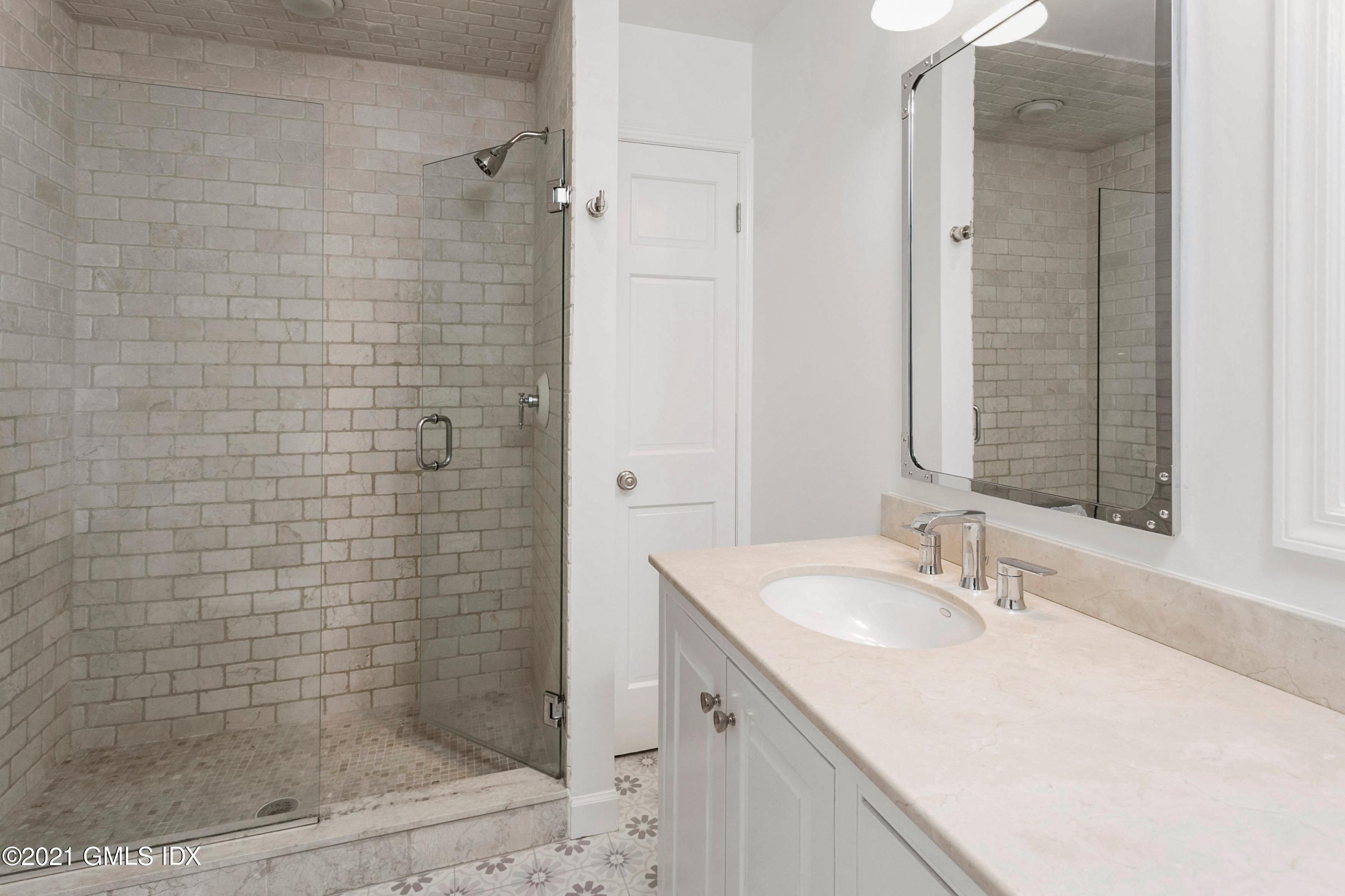 23 Stanwich Road Greenwich, CT 06830 - Photo 18 of 25 a bathroom with a sink shower and a mirror