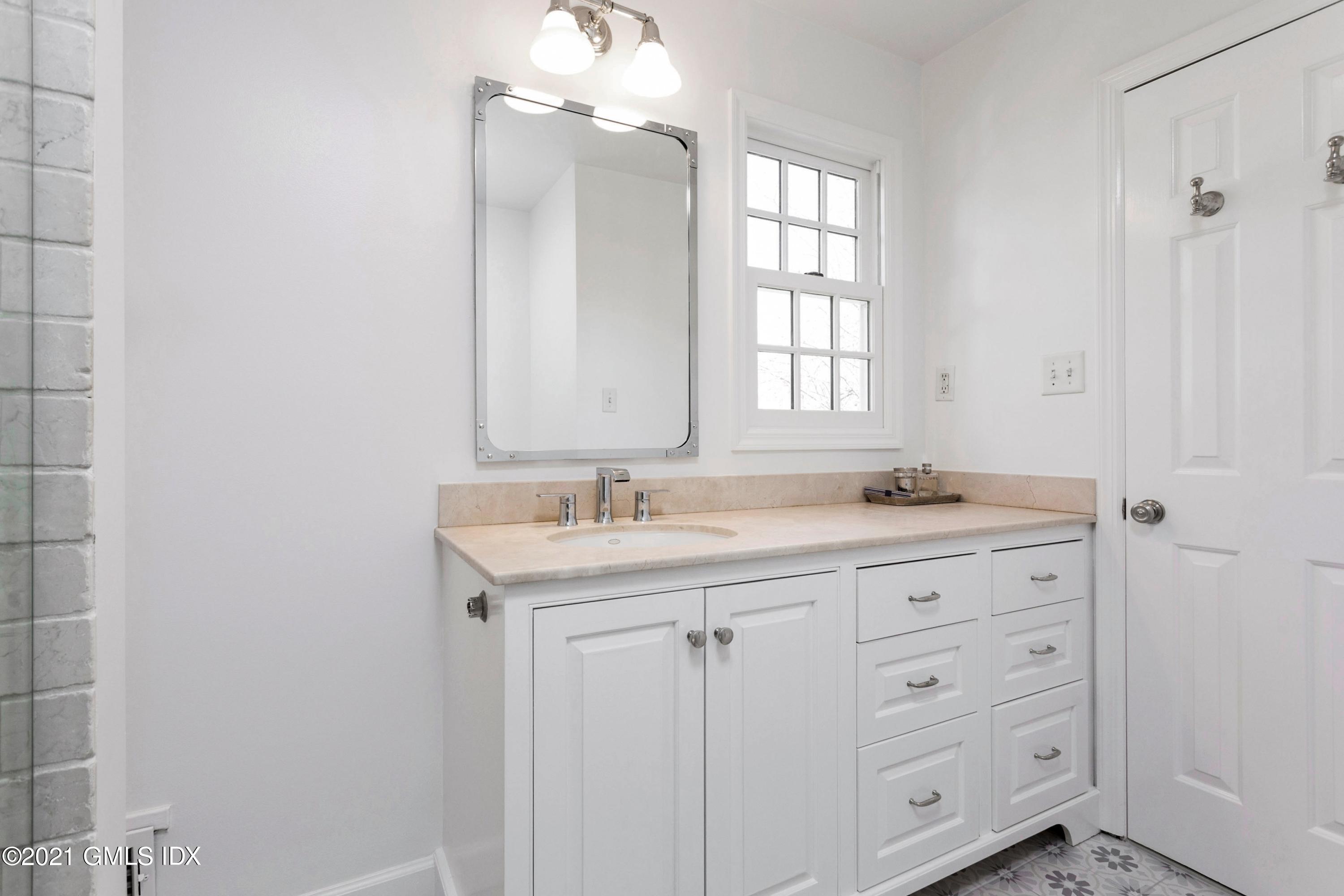23 Stanwich Road Greenwich, CT 06830 - Photo 19 of 25 a bathroom with a granite countertop sink and a mirror