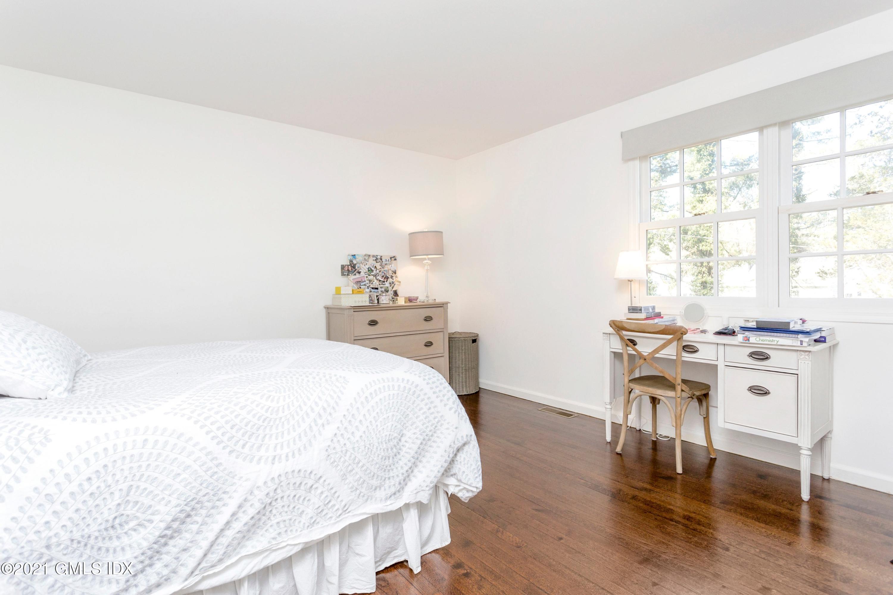 23 Stanwich Road Greenwich, CT 06830 - Photo 20 of 25 a bedroom with a bed and a table