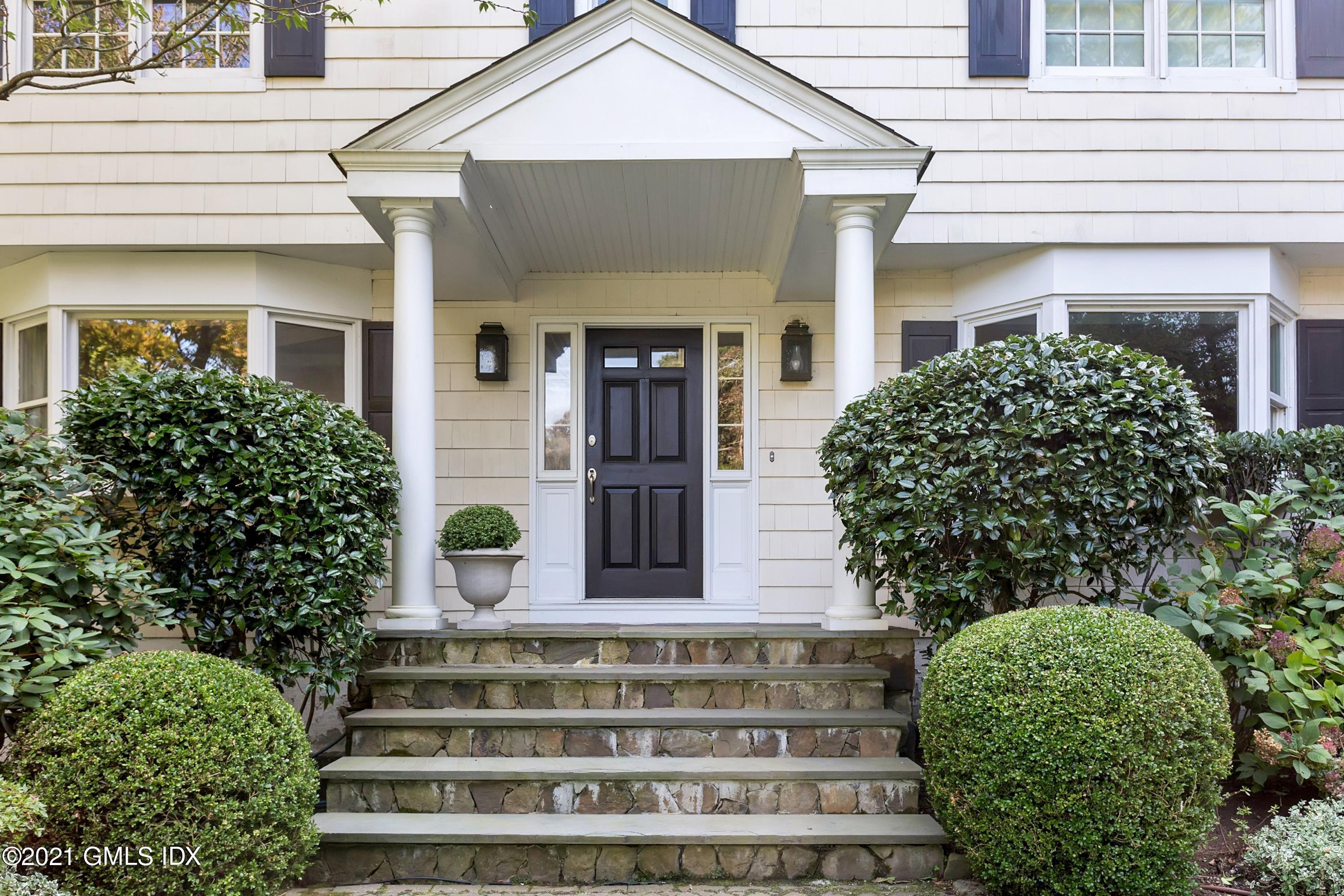 23 Stanwich Road Greenwich, CT 06830 - Photo 4 of 25 a front view of a house with a garden