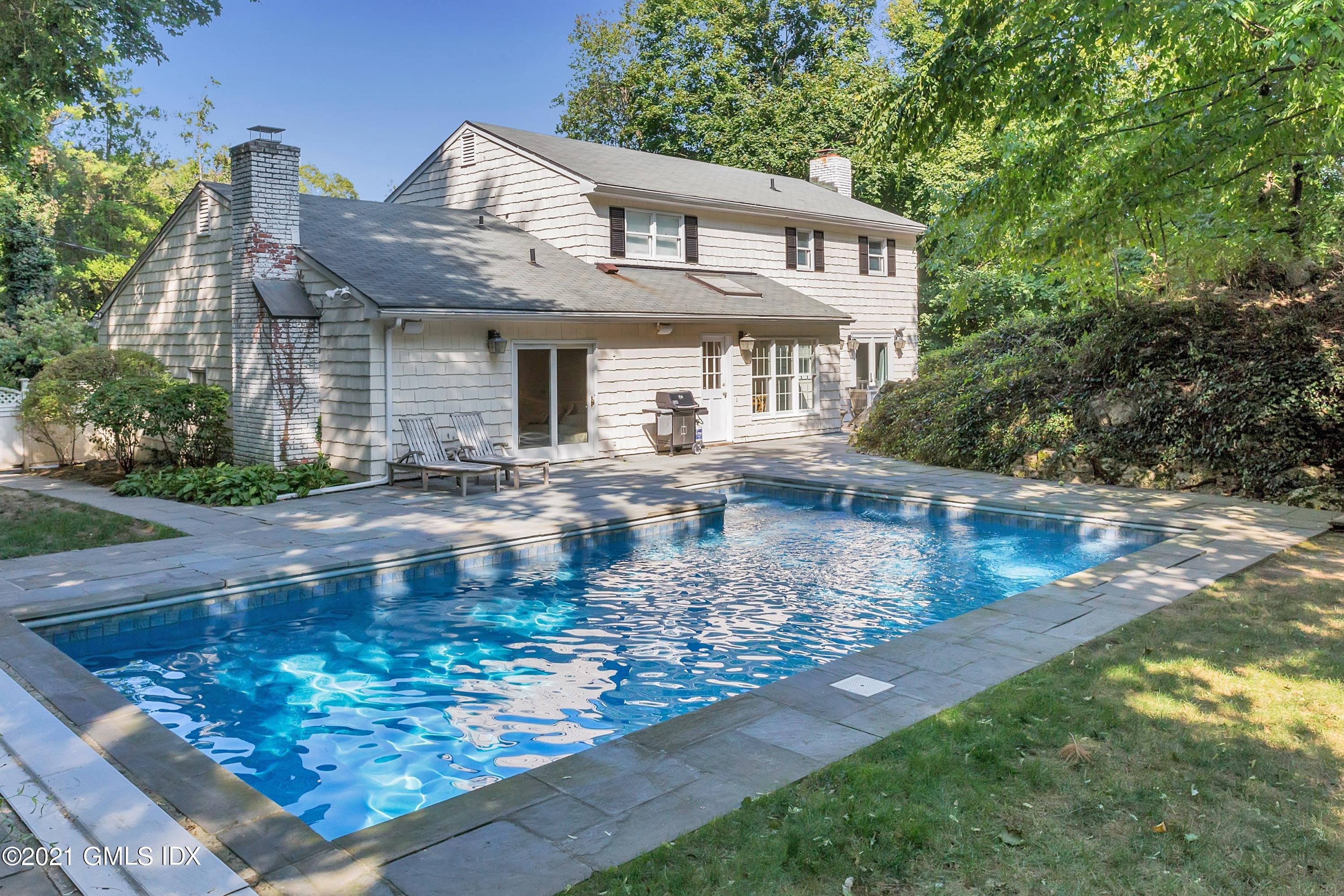23 Stanwich Road Greenwich, CT 06830 - Photo 5 of 25 a front view of a house with garden