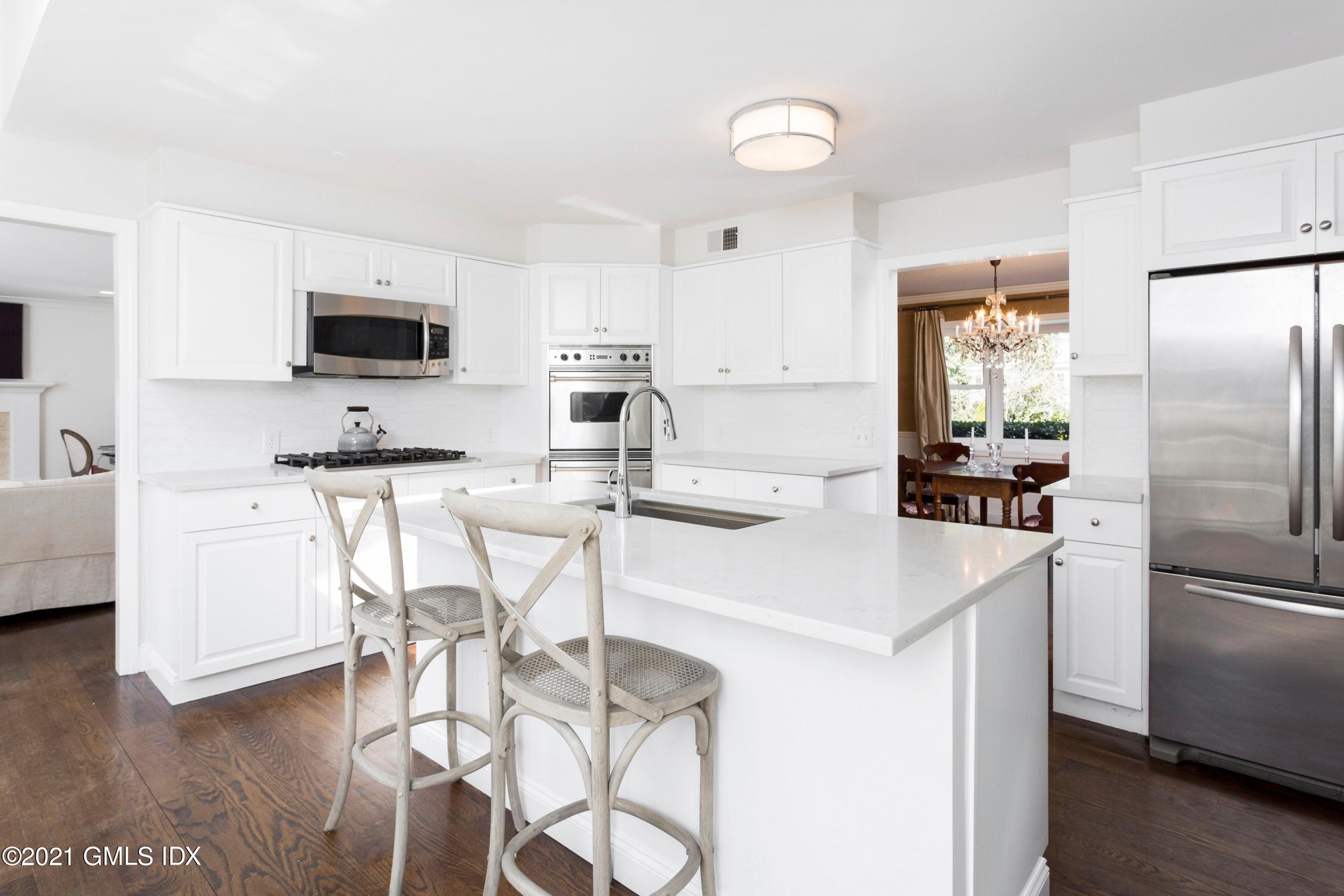 23 Stanwich Road Greenwich, CT 06830 - Photo 7 of 25 a kitchen with stainless steel appliances kitchen island a refrigerator and a stove top oven