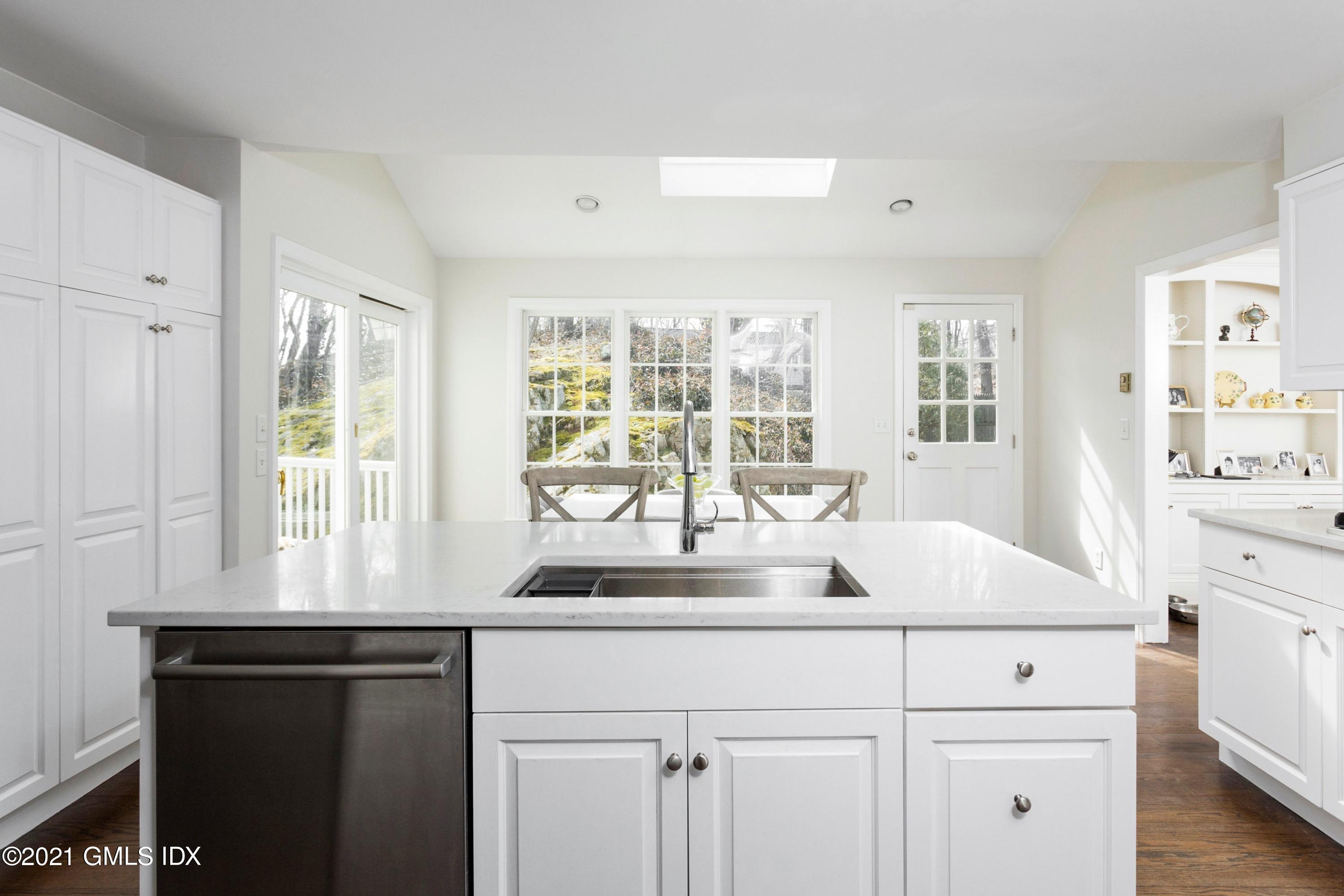23 Stanwich Road Greenwich, CT 06830 - Photo 10 of 25 a kitchen with stainless steel appliances white cabinets and a large window
